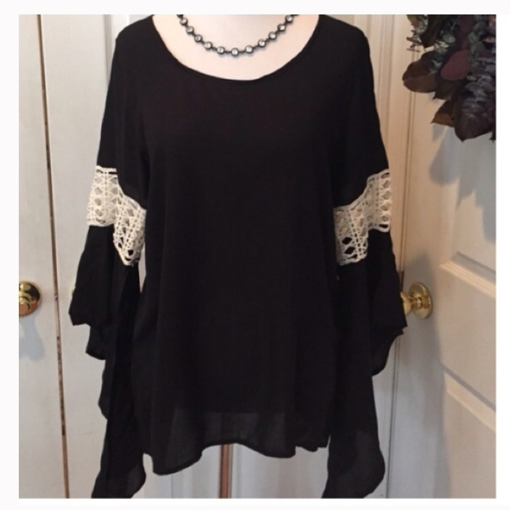 Lace sleeve detail on black rayon top